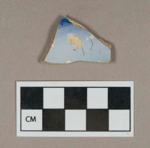 Ceramic, pearlware body sherd with flow blue decoration on interior