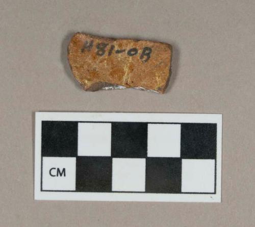 Ceramic, redware body sherd, glazed on both sides, exterior heavily weathered