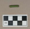 Synthetic, green rubber tube fragment