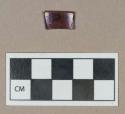 Glass, curved red and colorless glass fragment