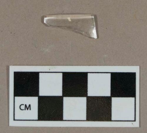 Glass, colorless curved rim fragment