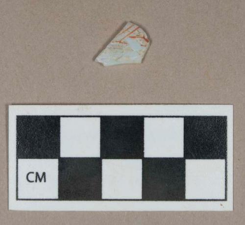 Glass, decorated opaque/white curved body fragment