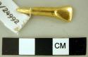 Gold pendant in shape of tooth with long root- hollow back