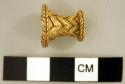 Gold nose or lip clip, with raised herringbone pattern.  Cylinder with lipped en