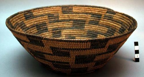 Medium-sized basket, coiled. Geometric designs.