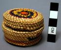 Miniature wrapped twined grass basket (A) with lid (B); geometric motifs