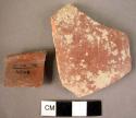 2 potsherds - red glaze slip