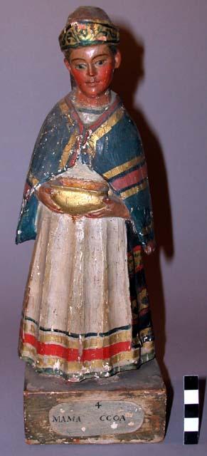 Standing female figure, wearing long skirt (postconquest style?) with native-sty