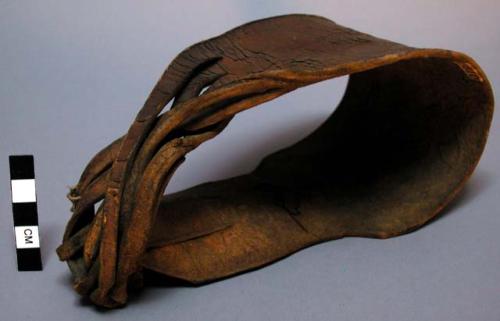 Wooden saddle covered with rawhide. Bead decoration.