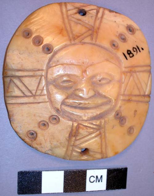 Round ivory pendant, human face