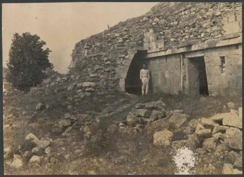 Kabah, Yucatan, structure 2C3, man in doorway of small temple behind palace