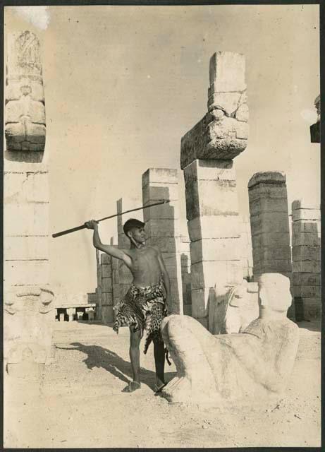 Boy next to Chac Mool at Temple of Warriors