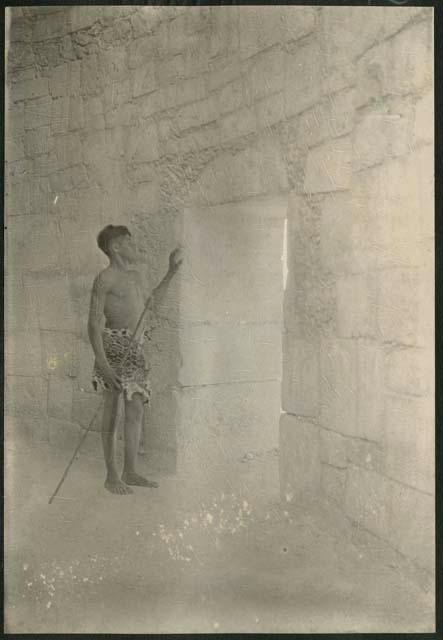 Caracol, boy standing in south doorway of outer annular chamber