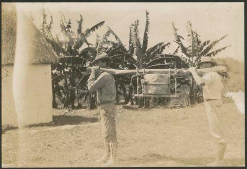 E. H. Morris and Gustav Stromsvik carrying plaque in urn to hacienda