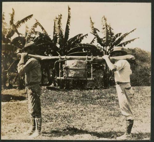 E. H. Morris and Gustav Stromsvik carrying plaque in urn to hacienda