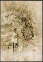 Boy standing in front of temple with standing roof