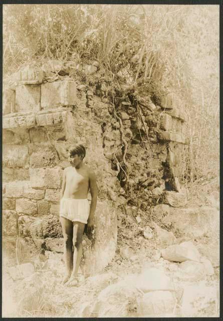 Boy standing in front of temple with standing roof