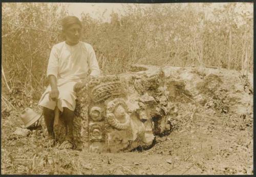 Boy with Tlaloc carved altar in milpa