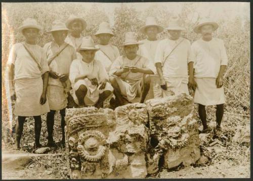 Group of men with Tlaloc carved altar in milpa