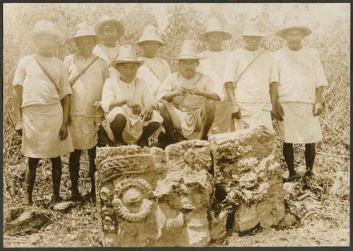 Group of men with Tlaloc carved altar in milpa