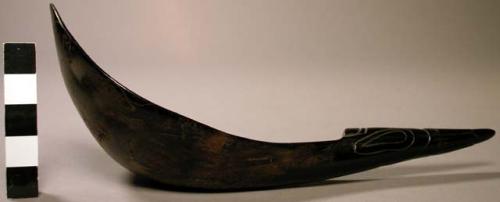 Ladle of black horn with a carved handle