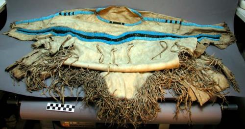 Woman's deerskin dress with blue and green beading on yoke and sleeves