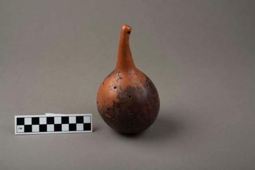 Hollow gourd with many holes made in it; contains something fragrant