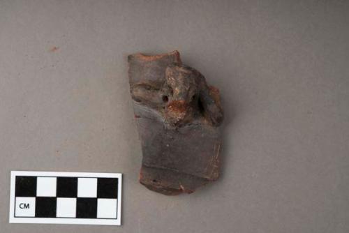 Fragment of black ware bowl, with modeled figure