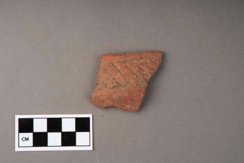 Potsherd - red incised (rim)