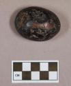 Ground stone, ovoid object, flat on one side, hematite