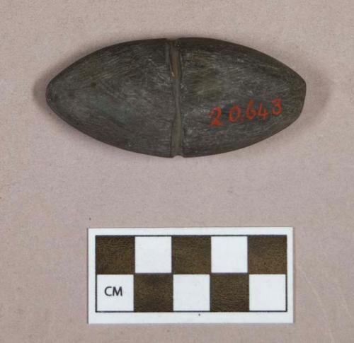 Ground stone, ovoid stone object, flat on one side, grooved around center