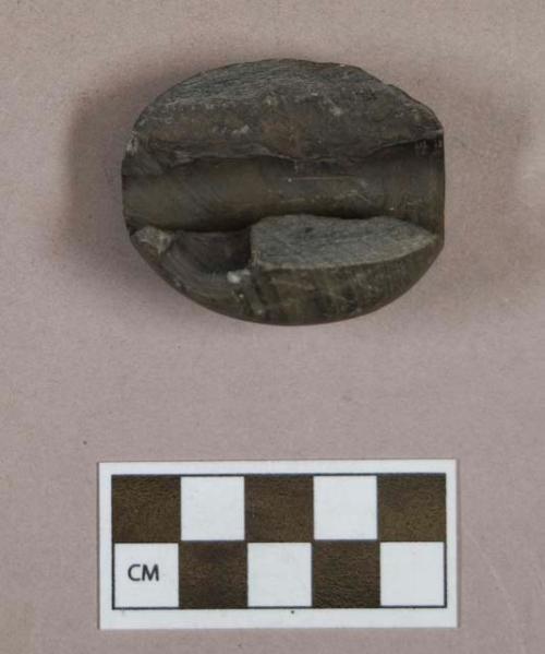 Ground stone, ovoid stone fragment, two perforations