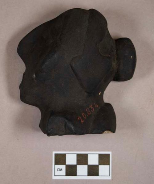 Plaster cast of ground stone effigy, human face in profile