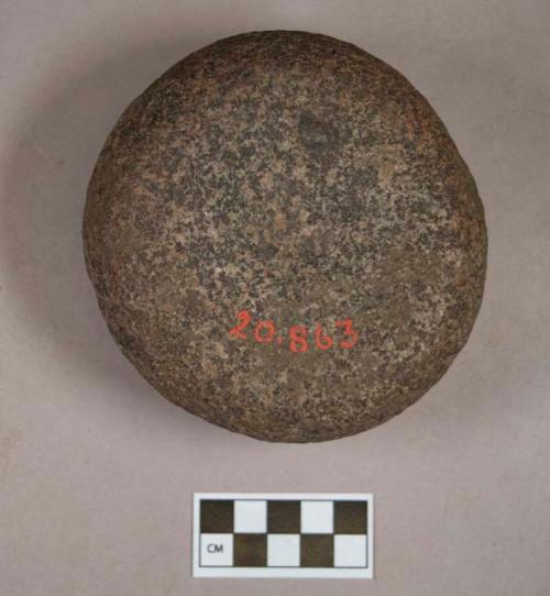 Ground stone, pounding stone, circular, pitted on one side