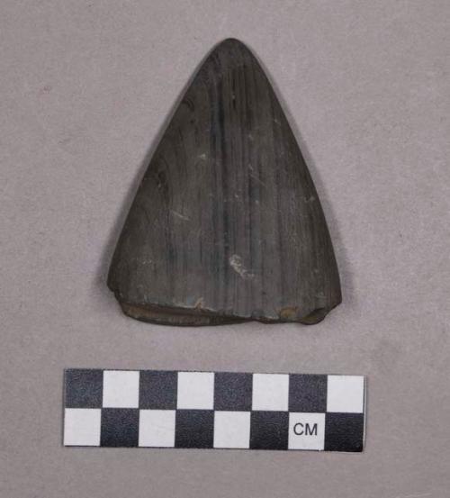 Ground stone, perforated fragment, triangular-shaped