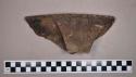 Ceramic, earthenware rim sherd, shell-tempered, notched rim, undecorated body, strap handle