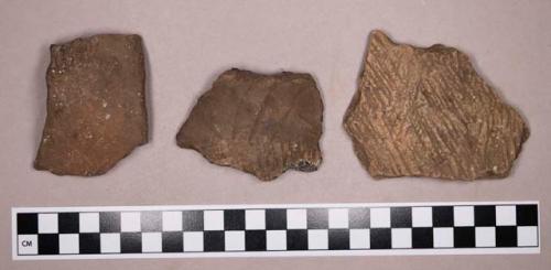 Ceramic, earthenware rim, body, and handle sherds, shell-tempered, cord-impressed, incised, and undecorated