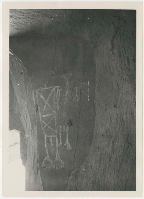 Pictographs of two human figures with rectangular bodies, missing heads, big hands and feet