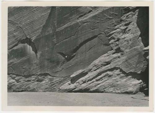 Overview of canyon wall with petroglyphs of humans and handprints