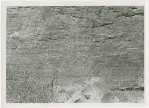 Lightly pecked petroglyph on side of canyon wall