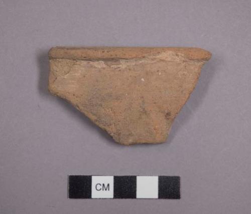 Pottery bowl rim with traces of grey blue slip