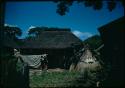 Two people in front of house