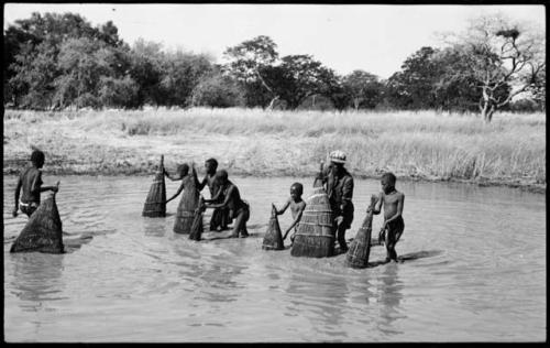 People fishing with baskets