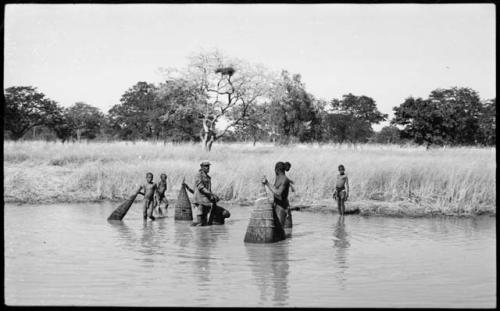 People fishing with baskets