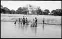 People fishing with baskets