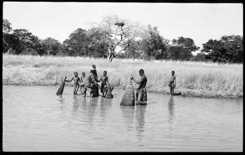 People fishing with baskets