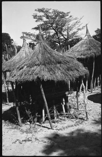 Storage basket, on poles, with thatched roof