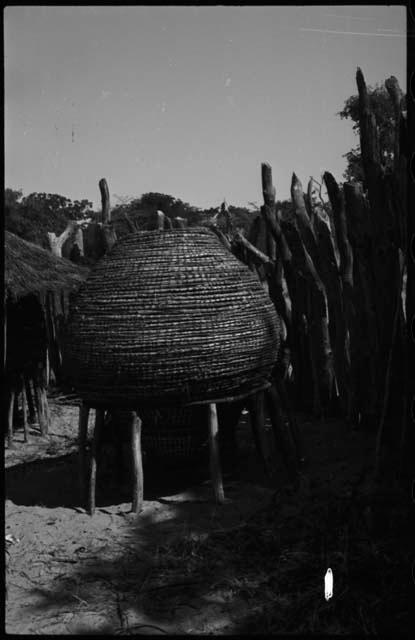 Storage basket, on poles, with thatched roof