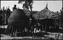 Woman standing at the top of storage basket, and two others standing below