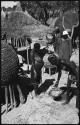 People standing near grain storage baskets